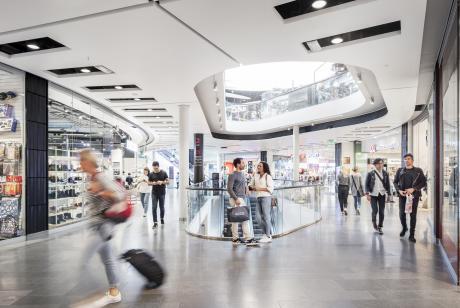 People walking and a couple laughing in the middle of Liljeholmstorget Galleria shopping center